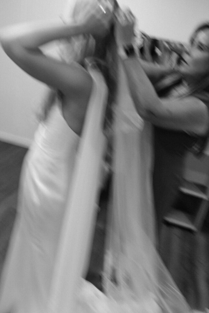 A mom placing the veil on the Bride's head before walking down the aisle