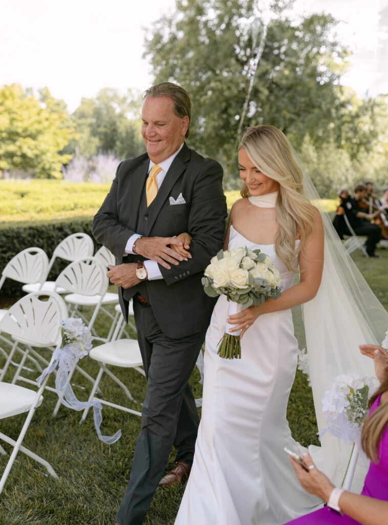 Father walks the bride down the grass aisle at Tyler Gardens