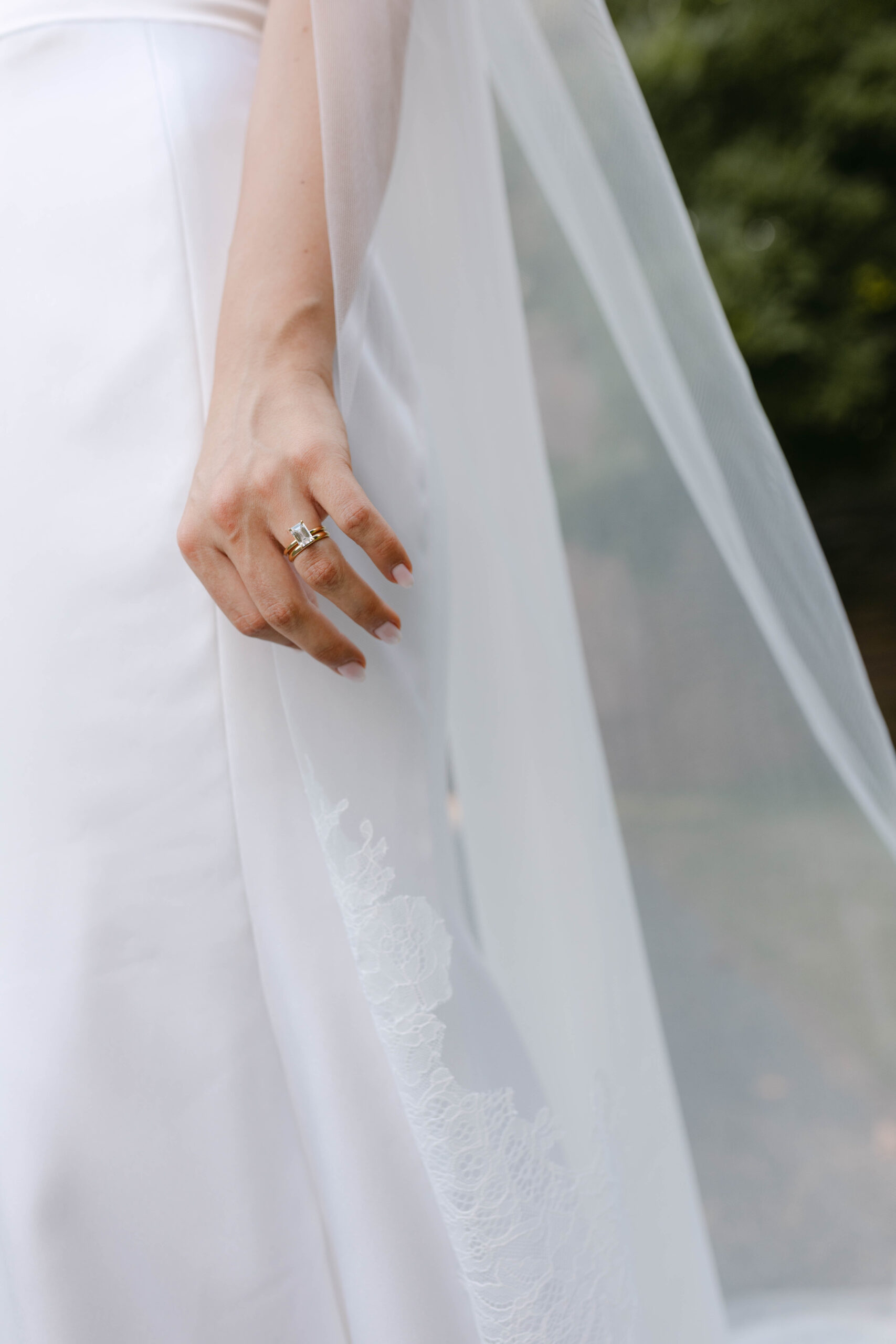 the bride and groom pose for portraits in a classic timeless white gown and black tuxedo in the lush gardens of Tyler Gardens