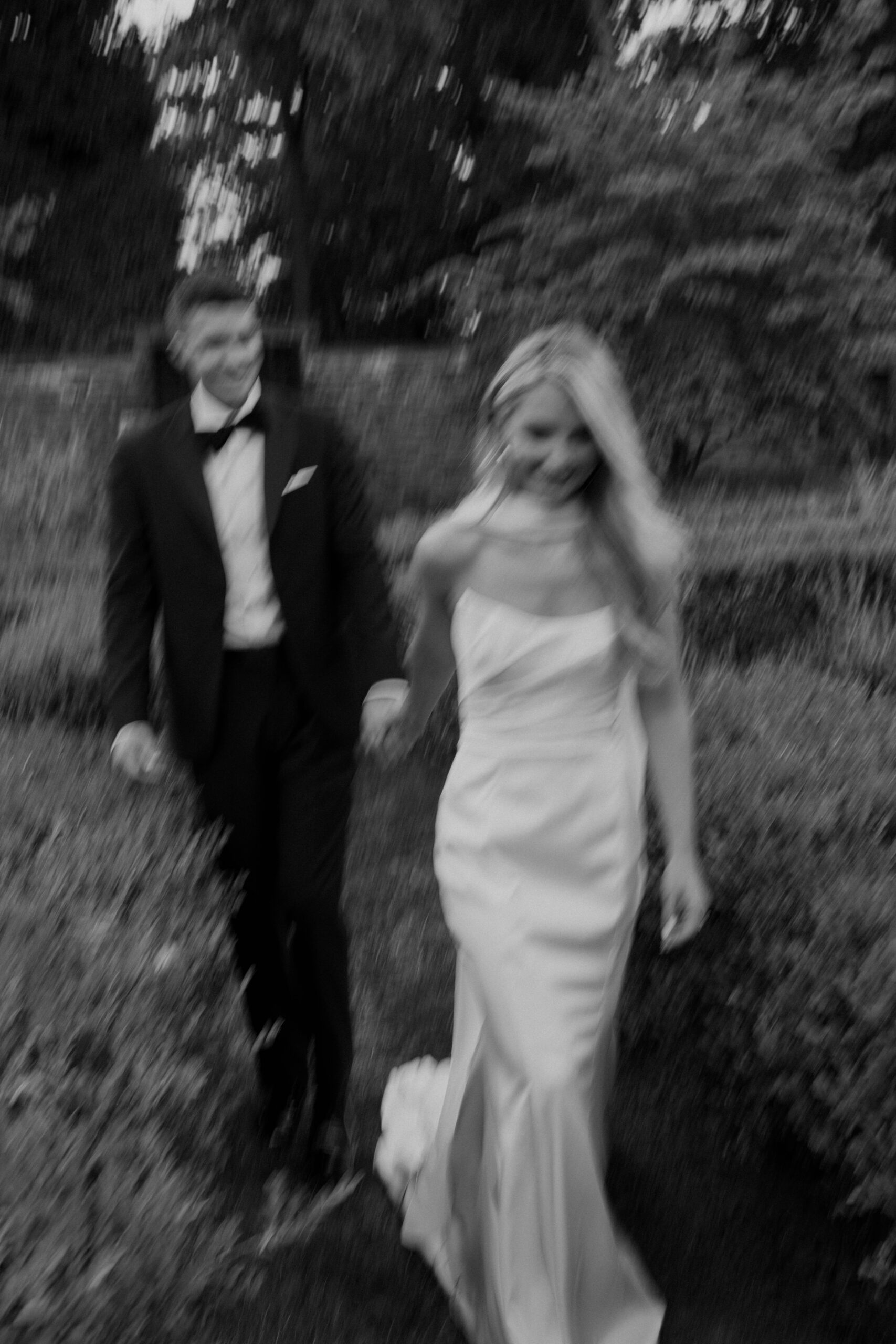 the bride and groom pose for portraits in a classic timeless white gown and black tuxedo in the lush gardens of Tyler Gardens